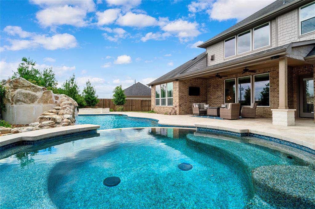 a view of a house with swimming pool and sitting area