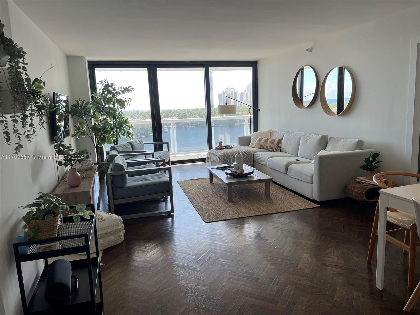 a living room with furniture fireplace and floor to ceiling window