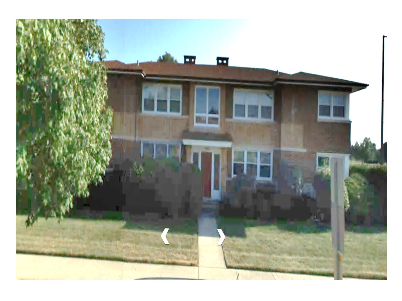 a view of a house with a backyard