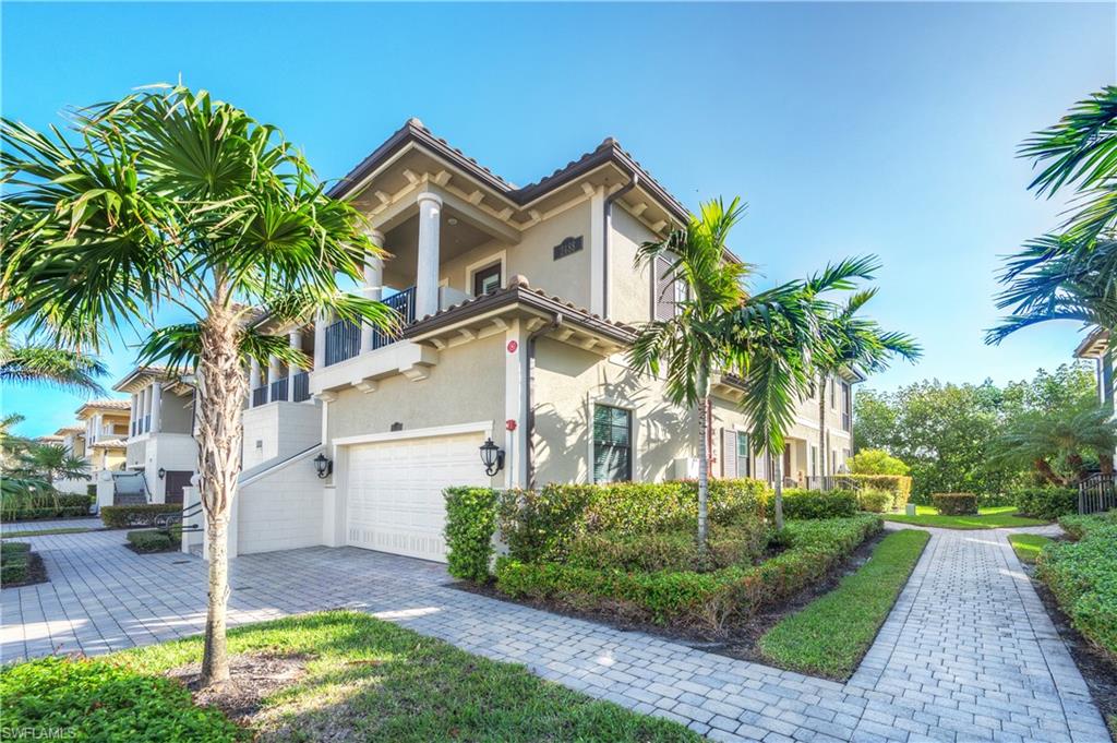 View of front of home with a garage and a balcony