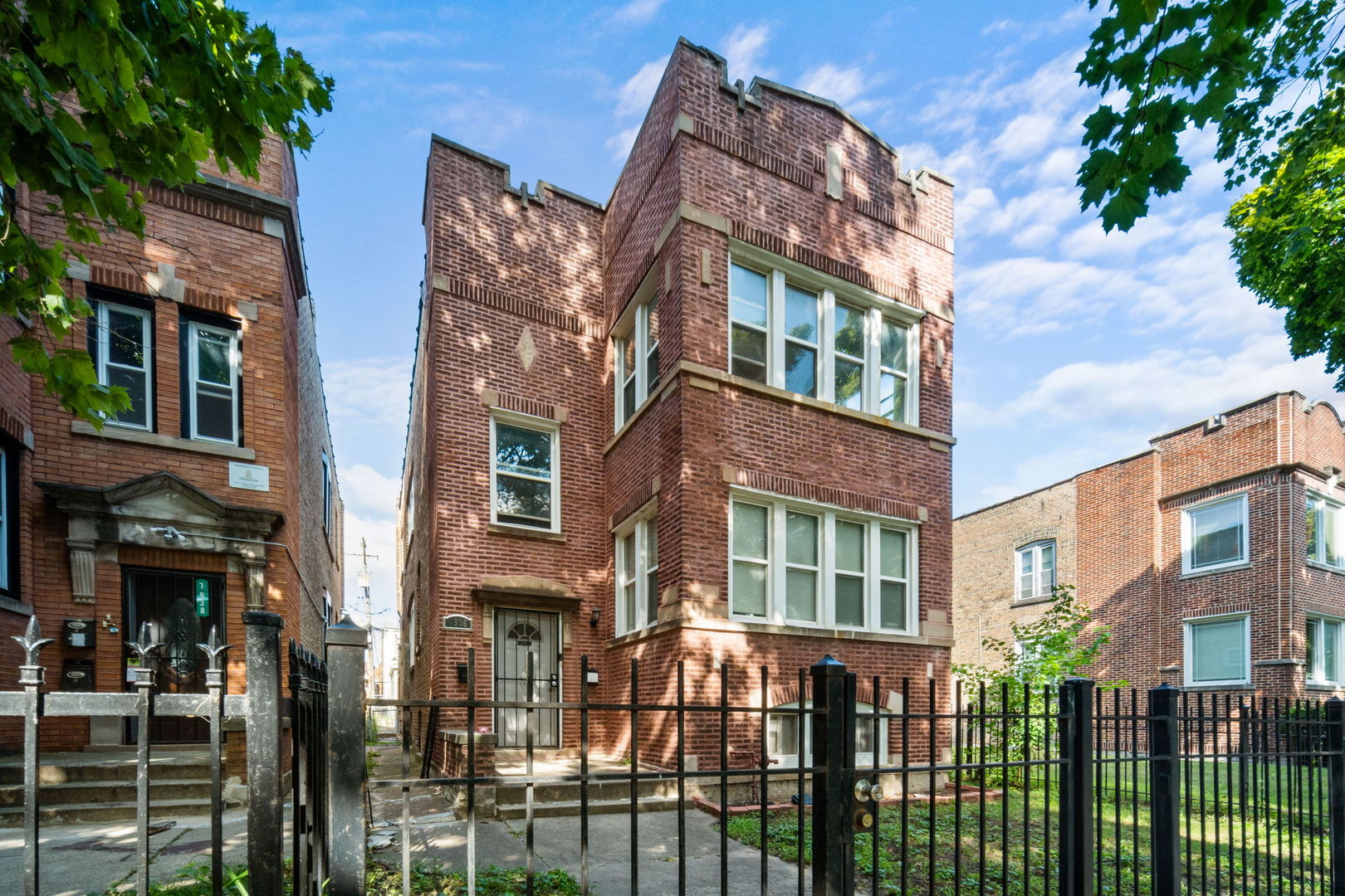 a view of a brick building next to a yard