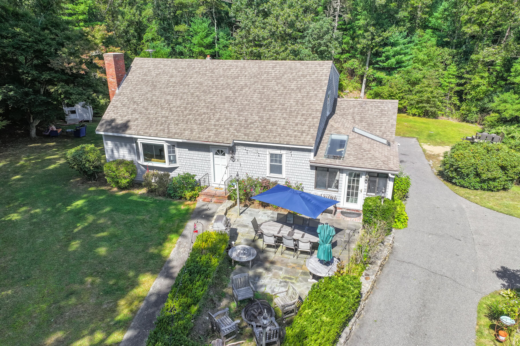 a aerial view of a house with yard and green space