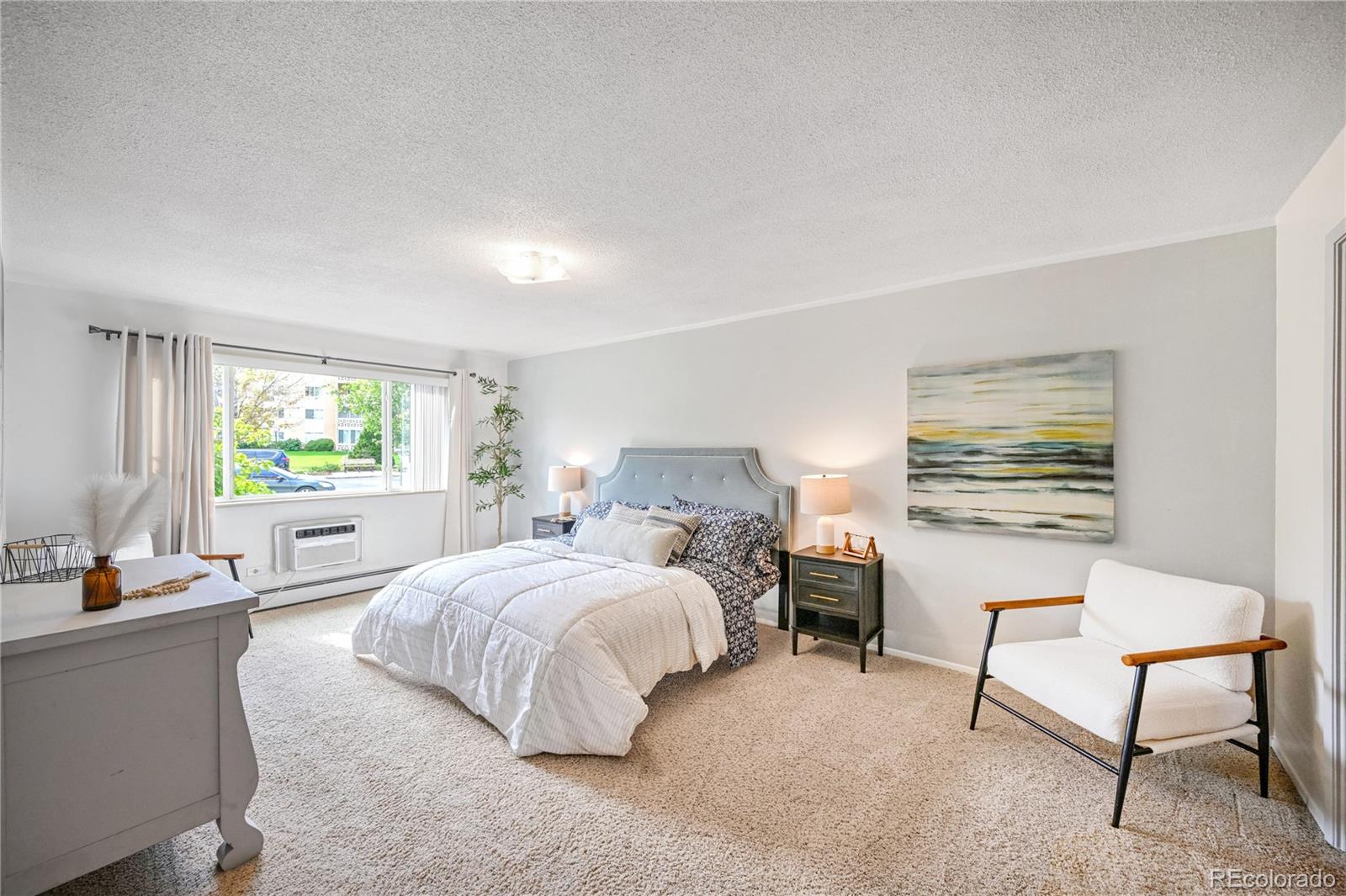 a bedroom with a bed chair and window