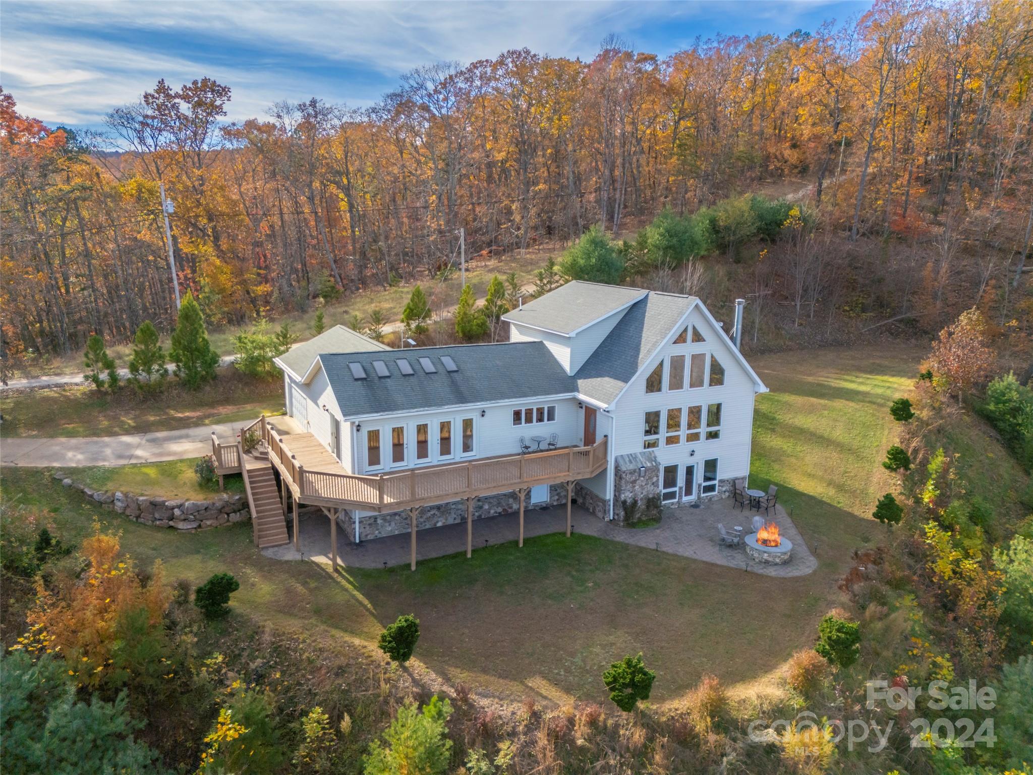 an aerial view of a house with a garden and trees