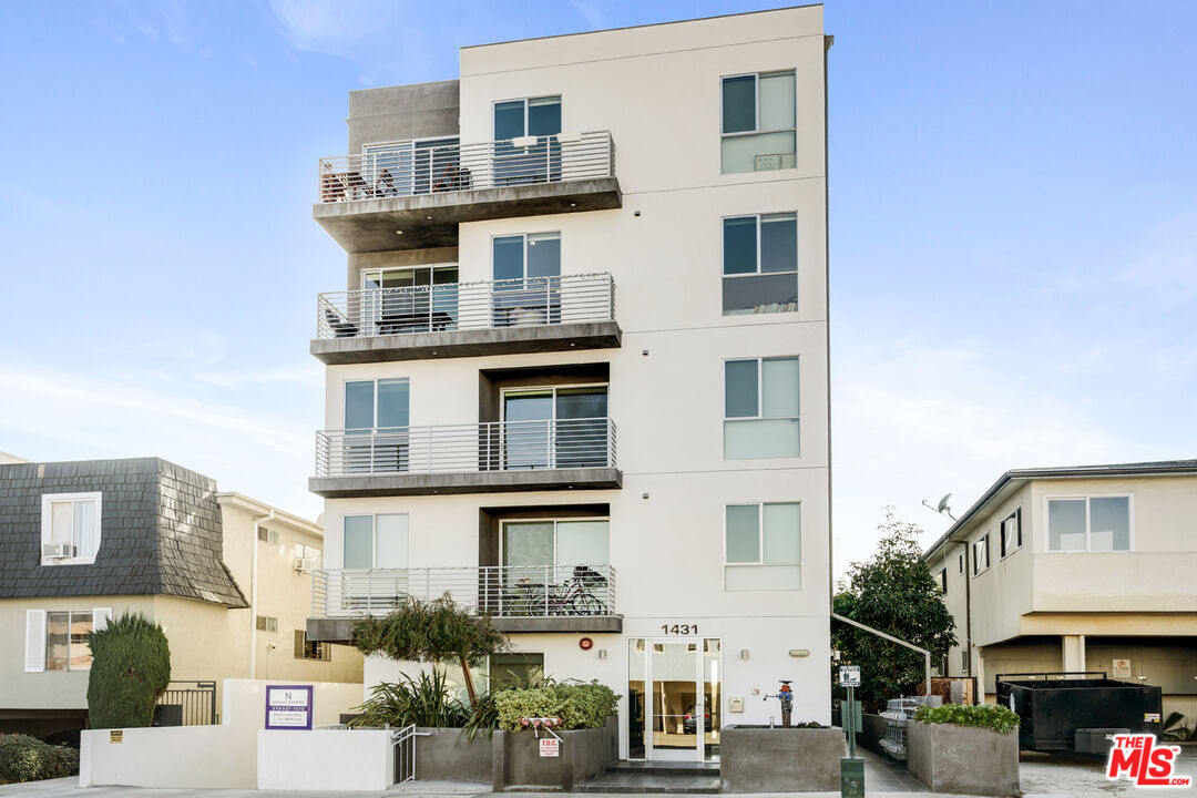 a front view of a residential apartment building with a yard