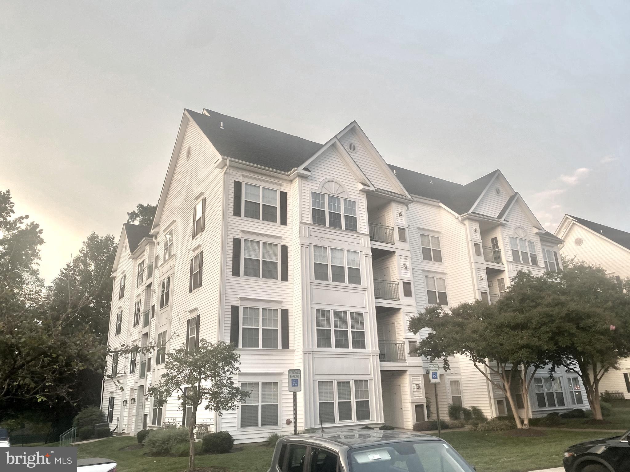 a front view of a residential apartment building with a yard