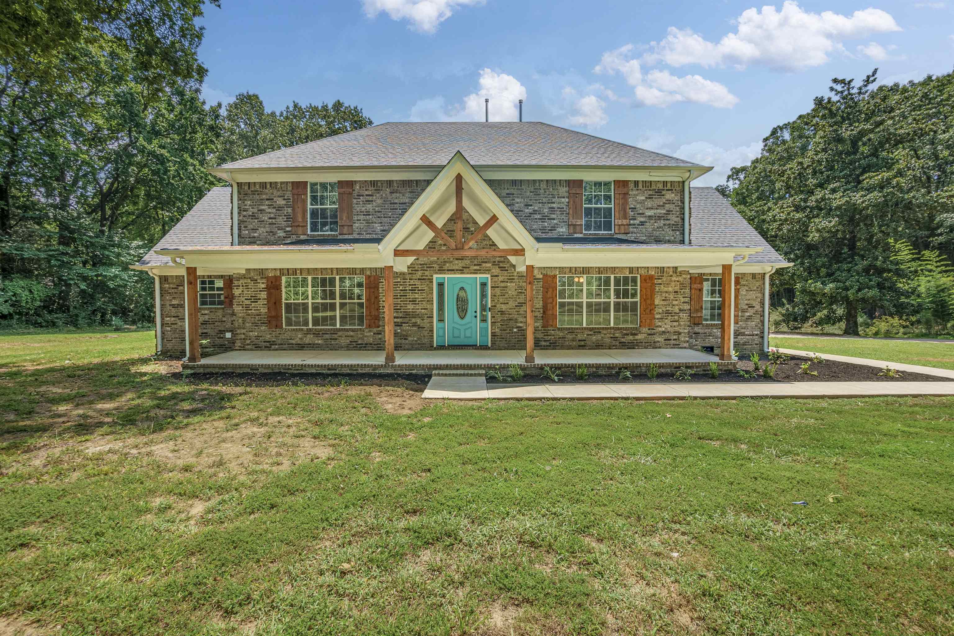 front view of a house with a yard