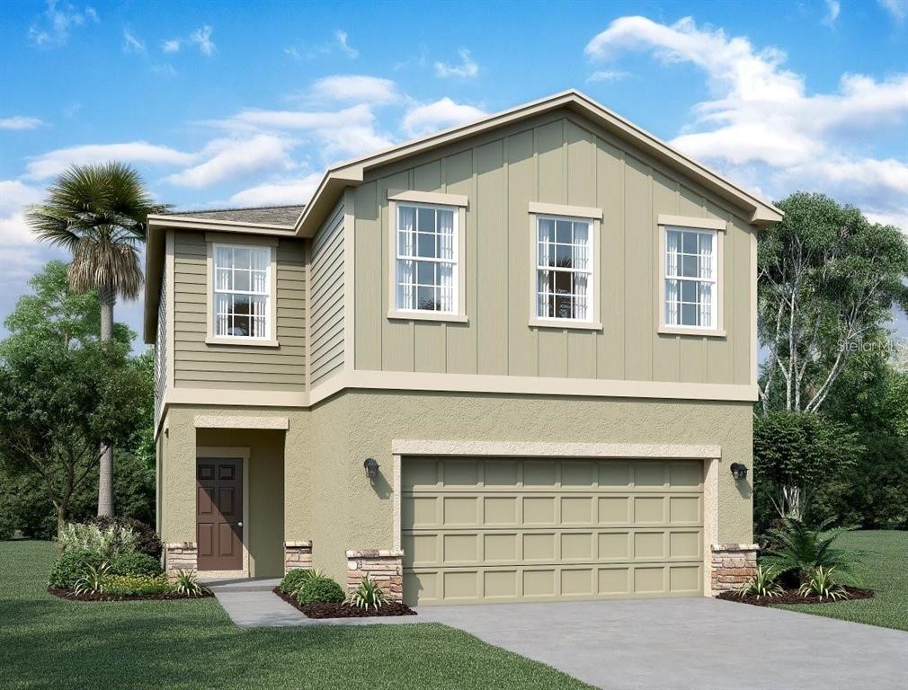 a front view of a house with a yard and garage