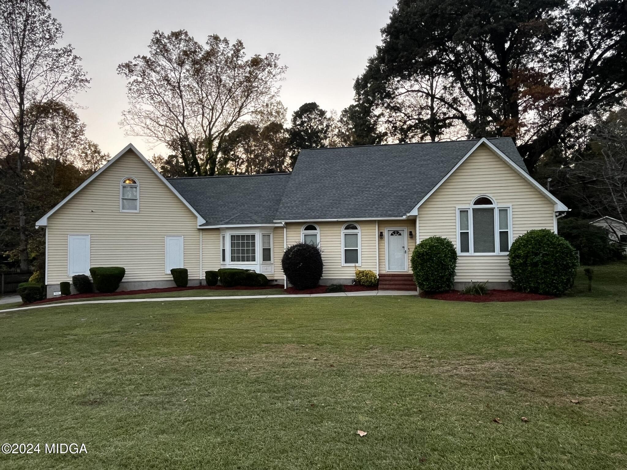 a front view of house with yard and green space