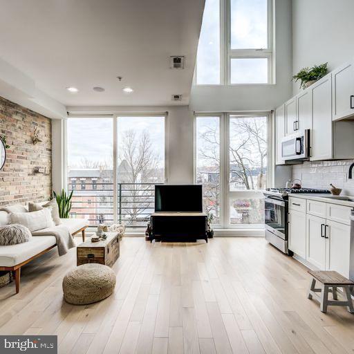 a living room with furniture and a large window