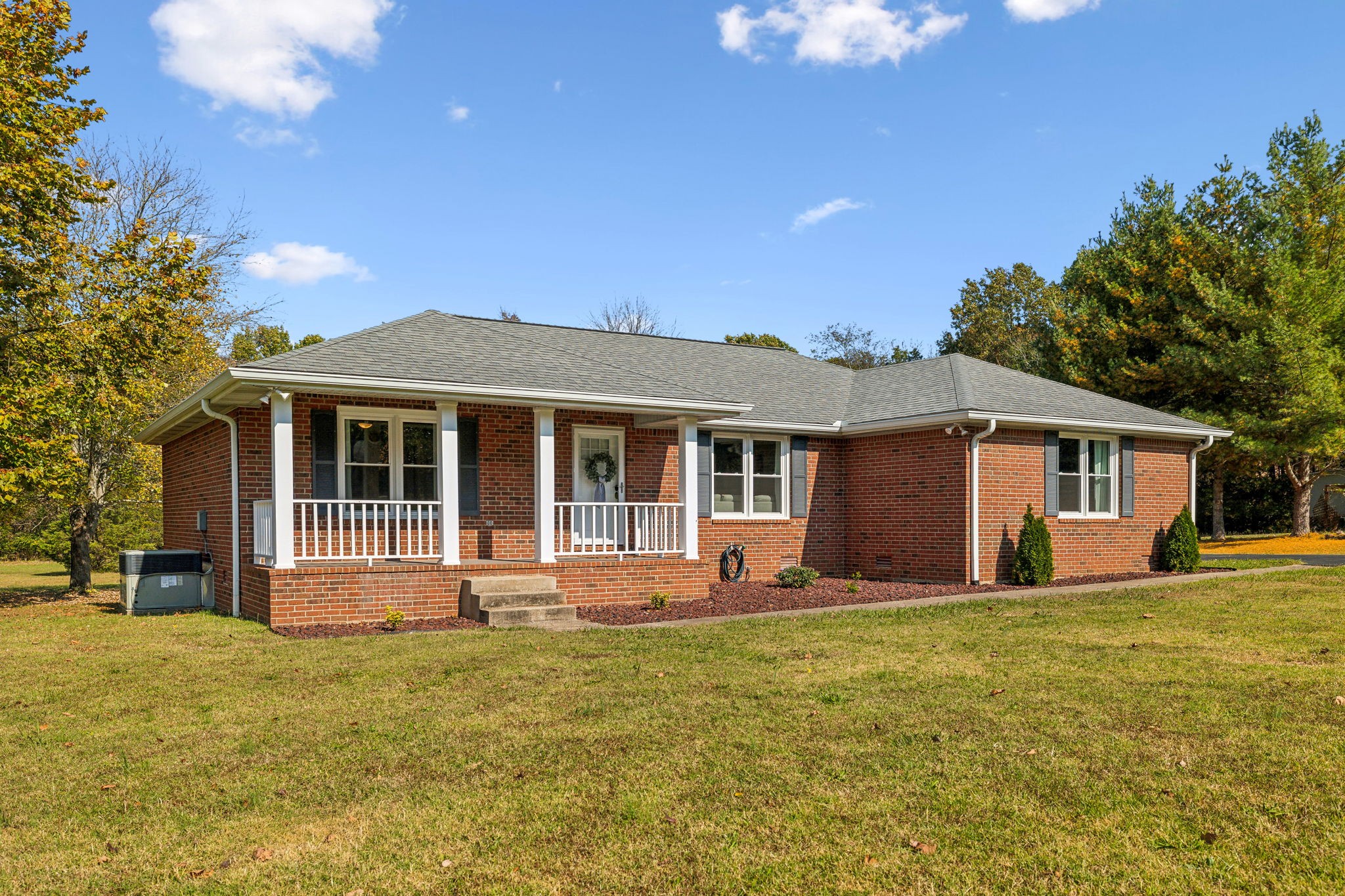 a front view of house with yard and green space