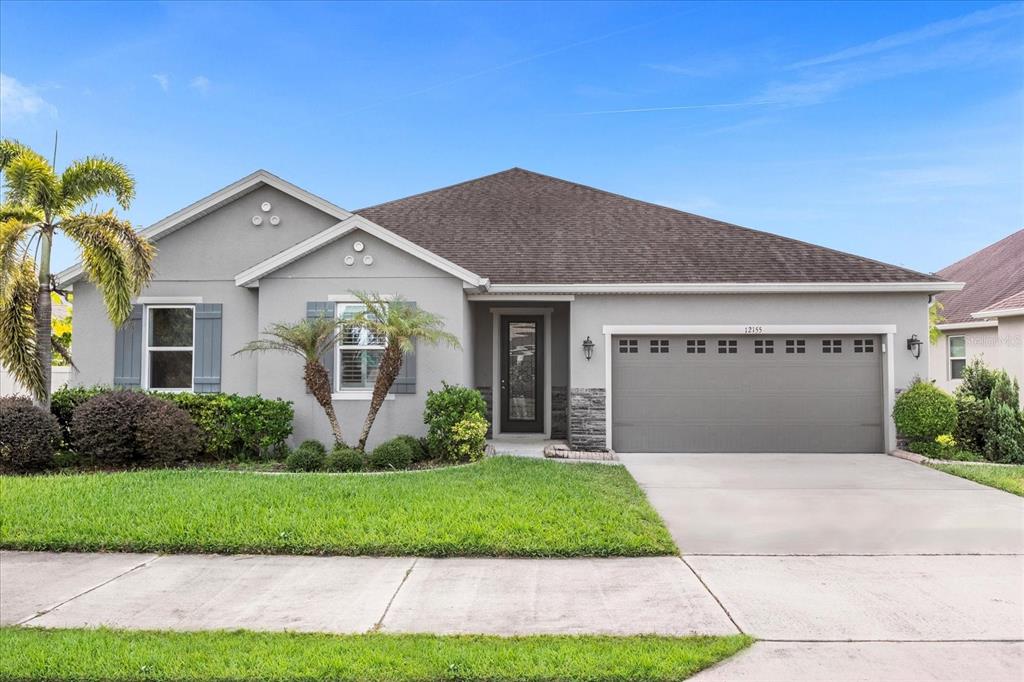 a front view of a house with a yard and garage