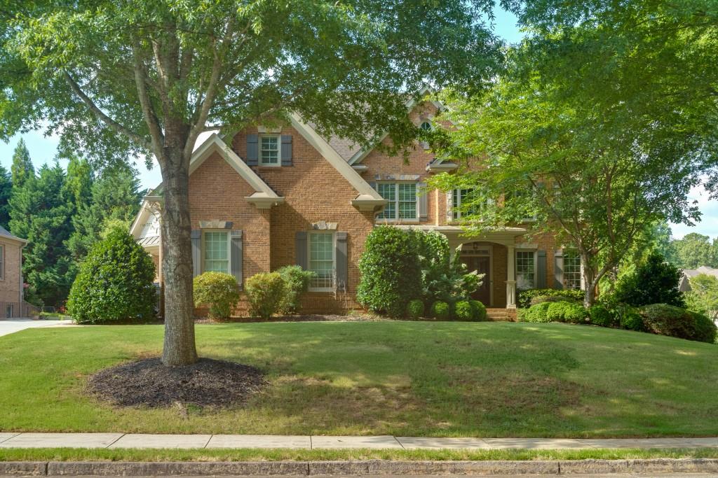 a front view of house with yard and green space