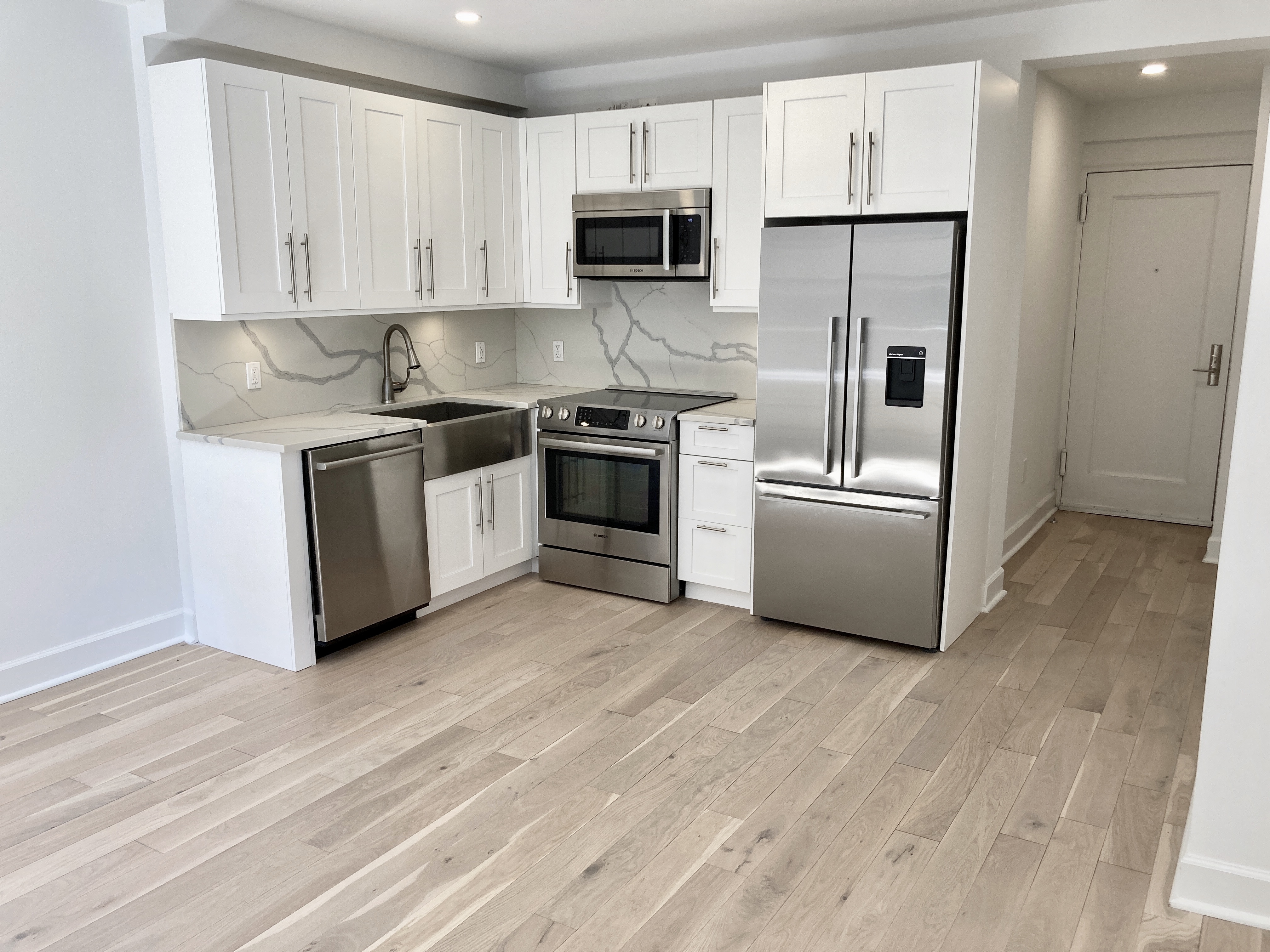 a kitchen with stainless steel appliances granite countertop a stove a sink and a refrigerator