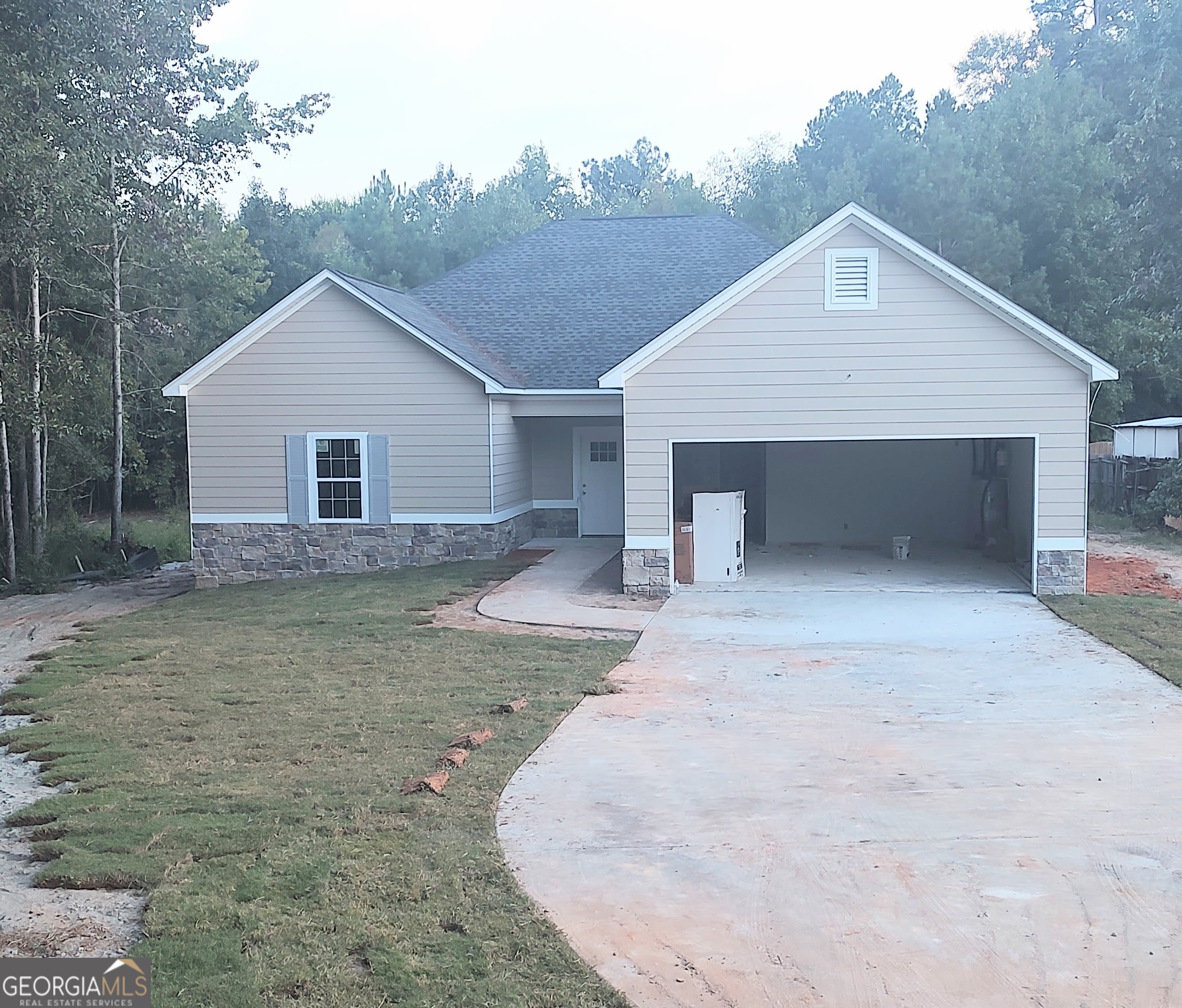 a view of a house with a yard and garage