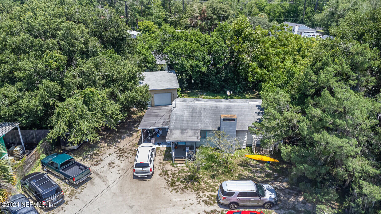 an aerial view of a house with garden space and street view