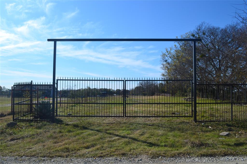 a view of a backyard with a fence