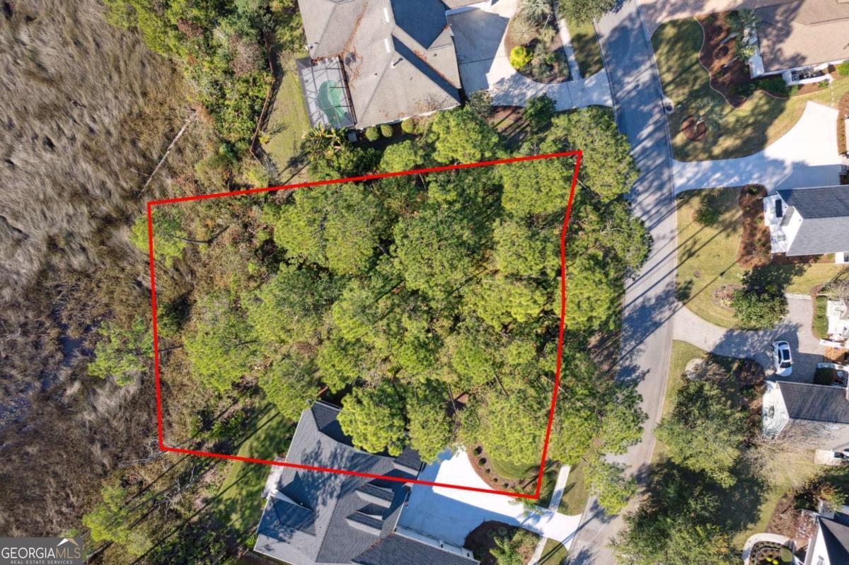 an aerial view of a houses with yard