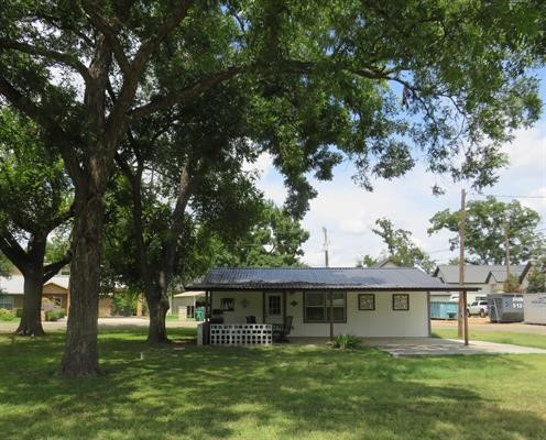 a front view of house with yard and trees