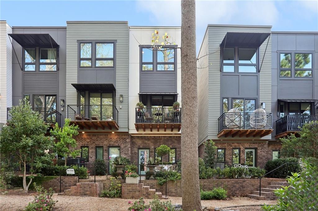 a front view of a house with a yard and balcony