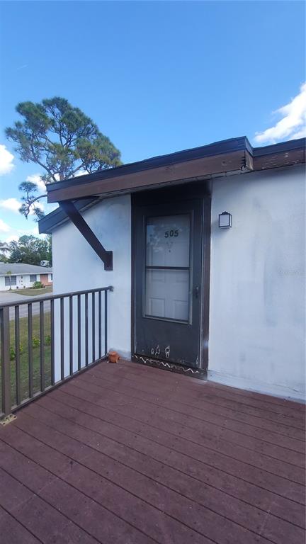 a view of a house with wooden deck