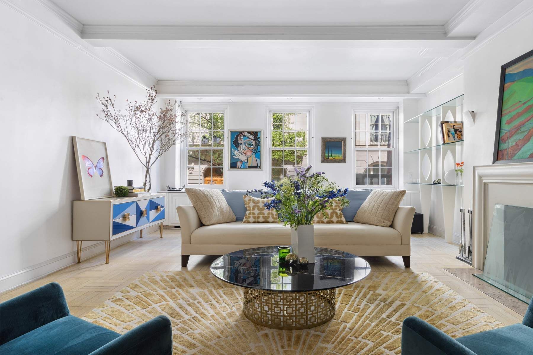 a living room with furniture fireplace and a large window