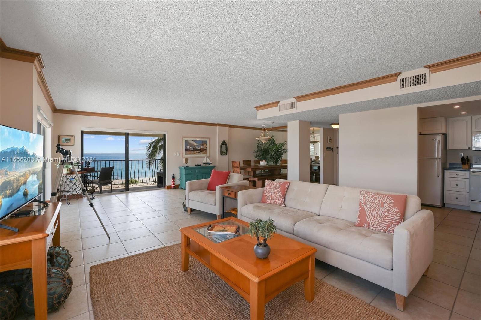 a living room with furniture a rug and a flat screen tv