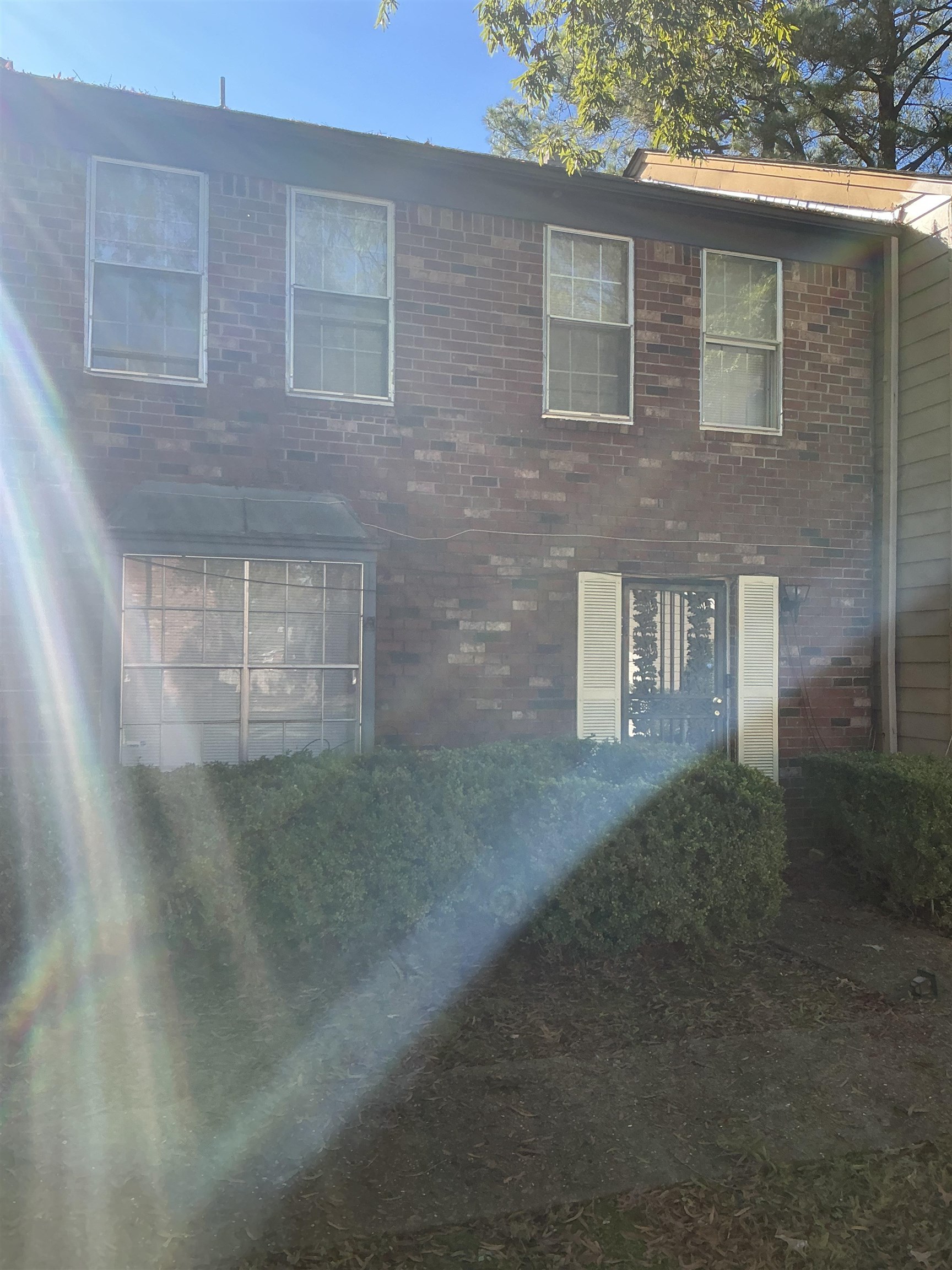 a view of a brick house with a yard