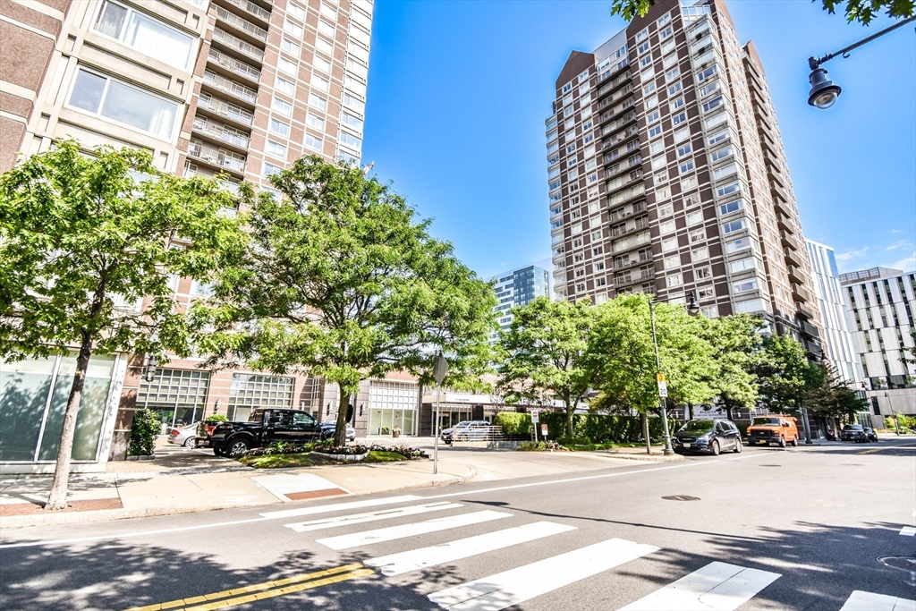 a view of a tall building next to a road