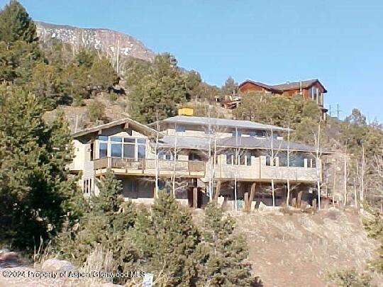 a large building with a view of a building with a mountain in the background