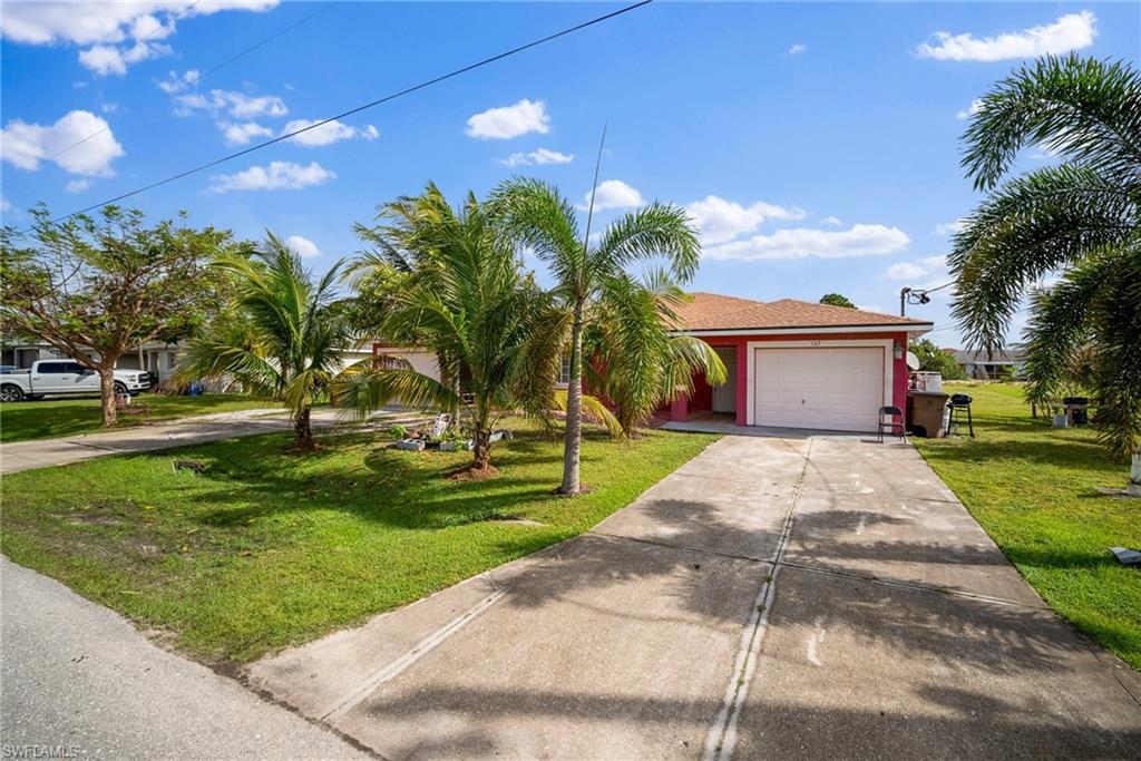 View of front of house featuring a garage and a front yard