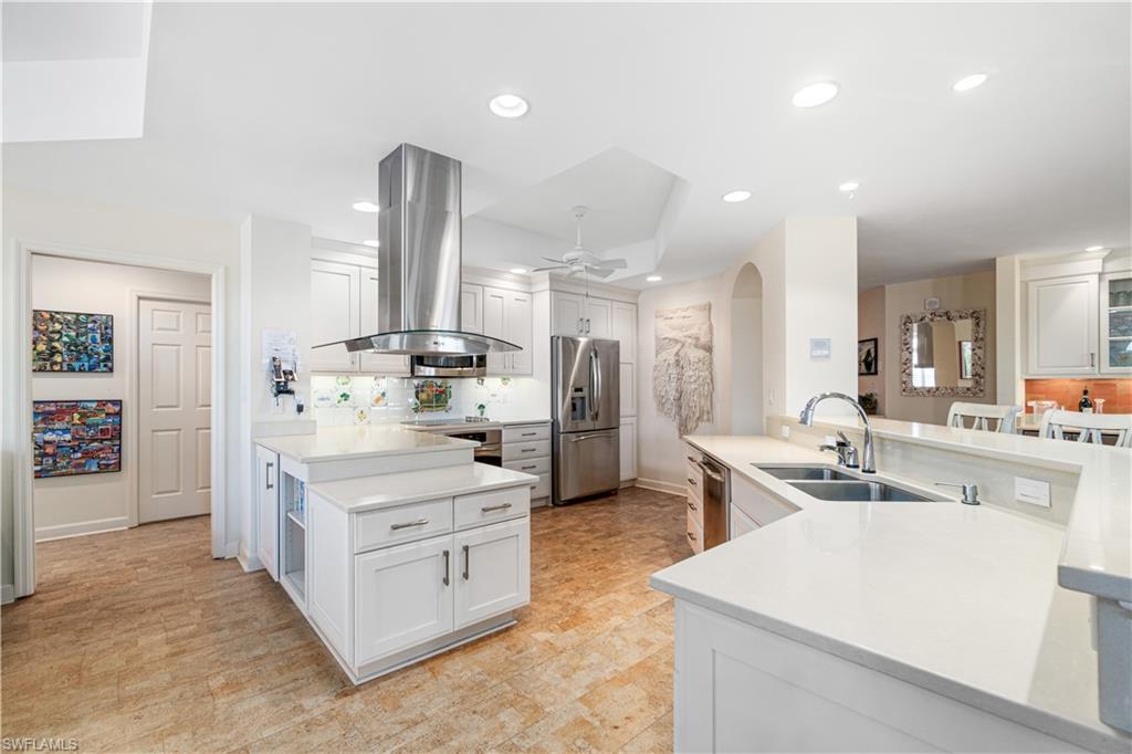 a kitchen with stainless steel appliances kitchen island granite countertop a sink and cabinets