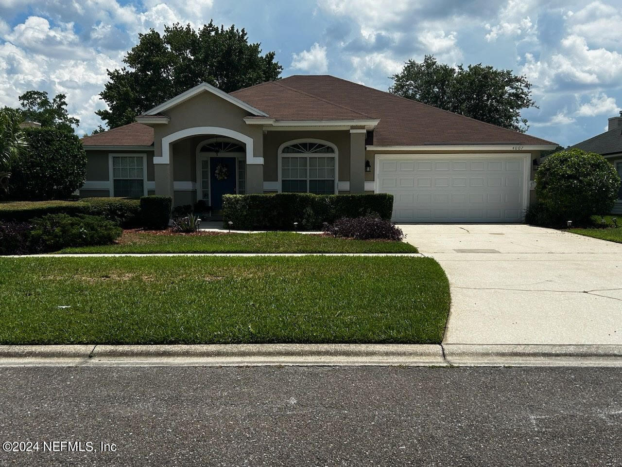 a front view of a house with a yard