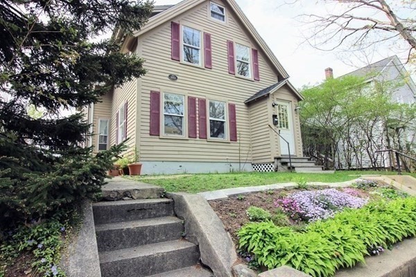 a front view of a house with garden