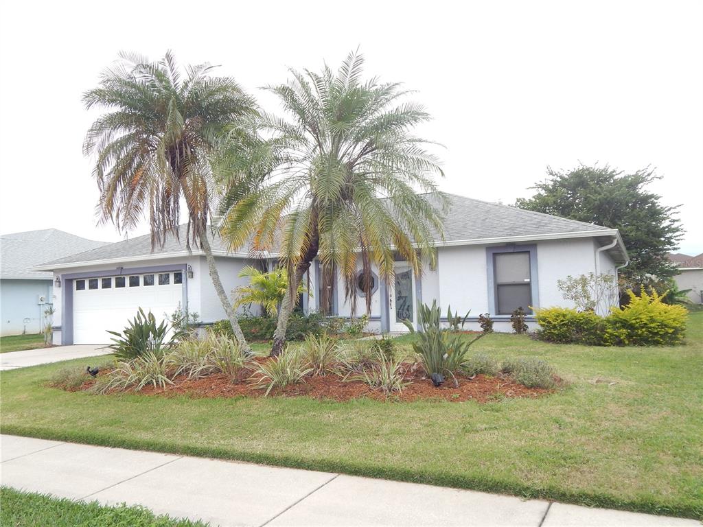 a front view of house with yard and green space