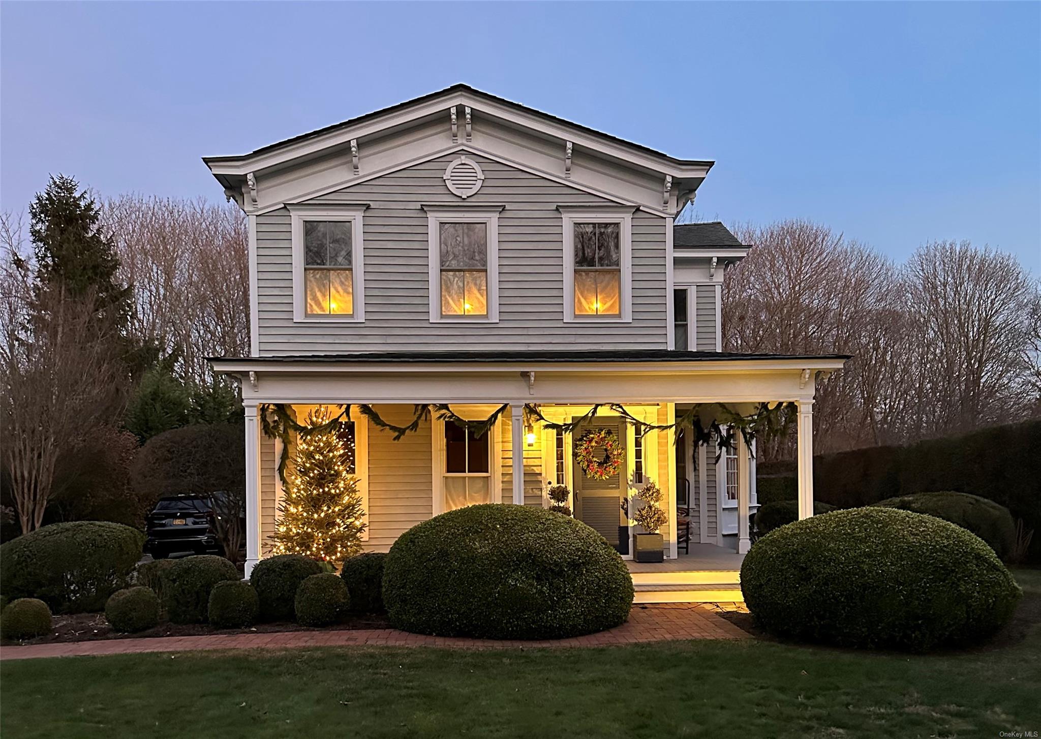 View of front of property with a lawn and covered porch