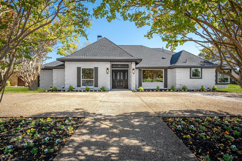 a house that has a tree in front of it