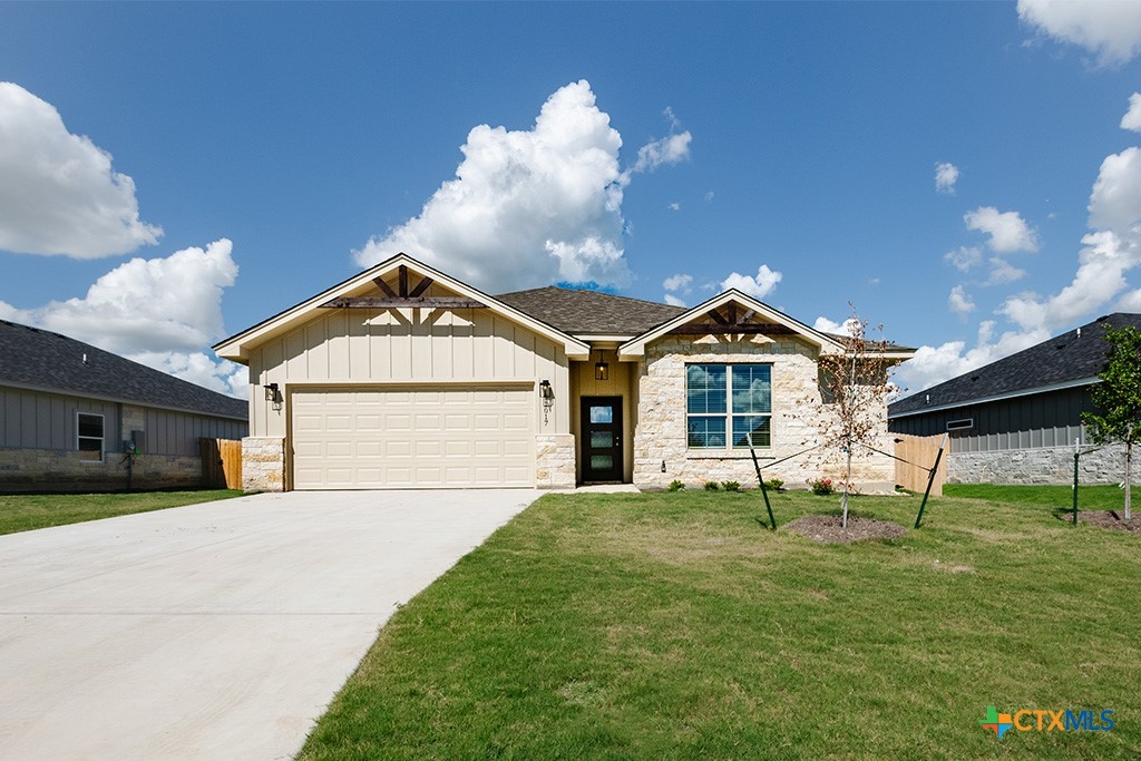 a front view of a house with a yard and garage