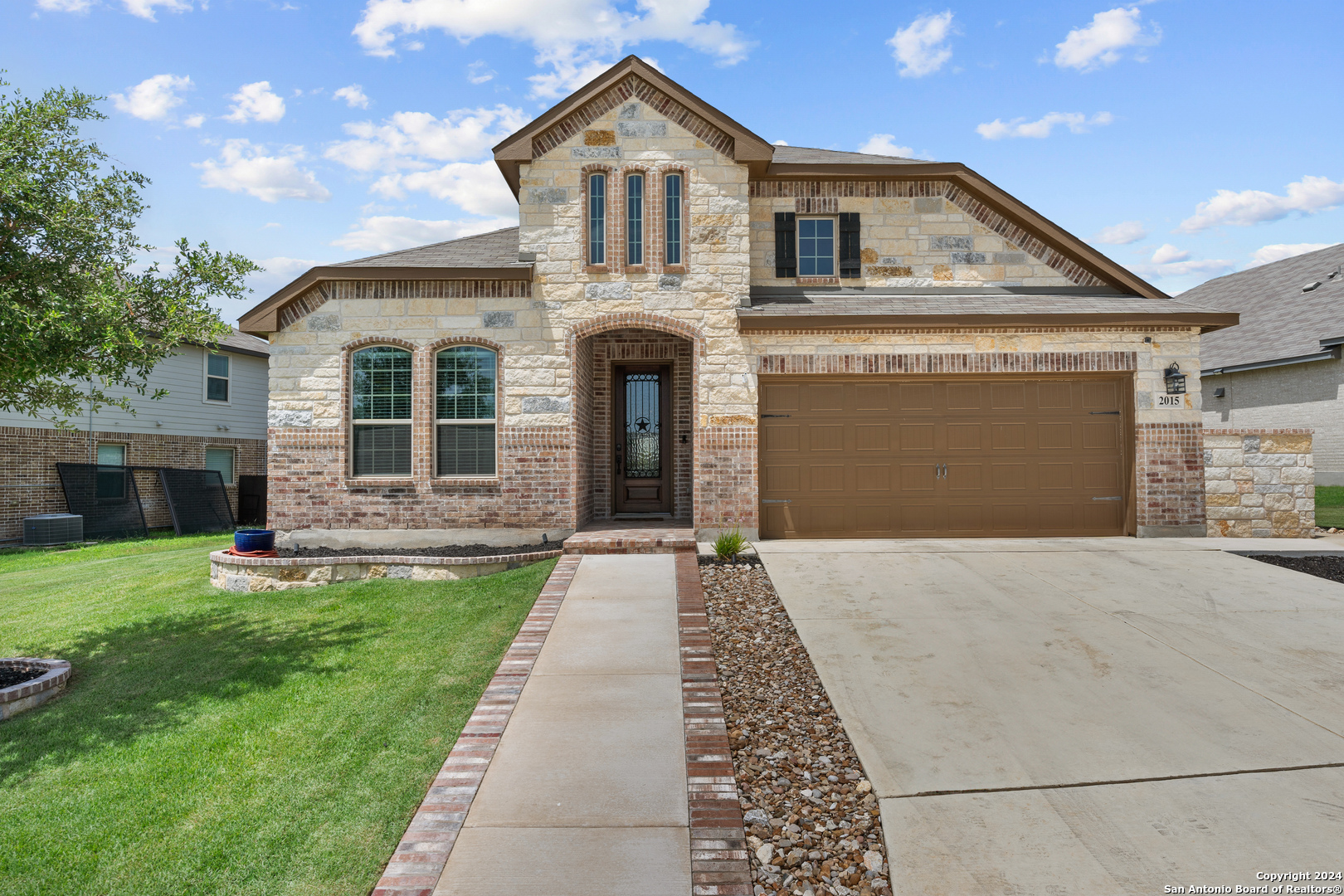 a front view of a house with a yard and garage