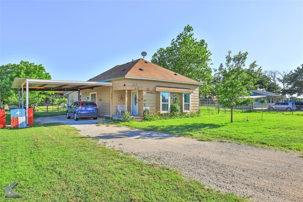 a front view of a house with a yard and porch