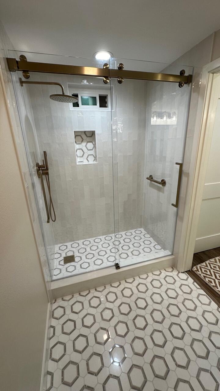 a bathroom with a shower and a sink