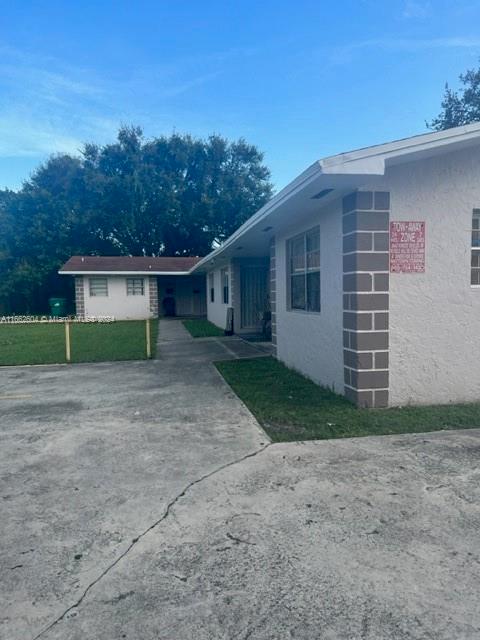 a view of house with outdoor space and a yard