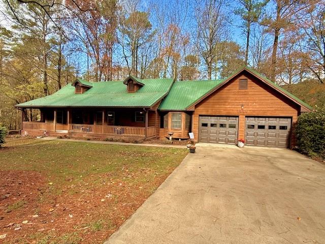 a front view of a house with a yard outdoor seating and garage