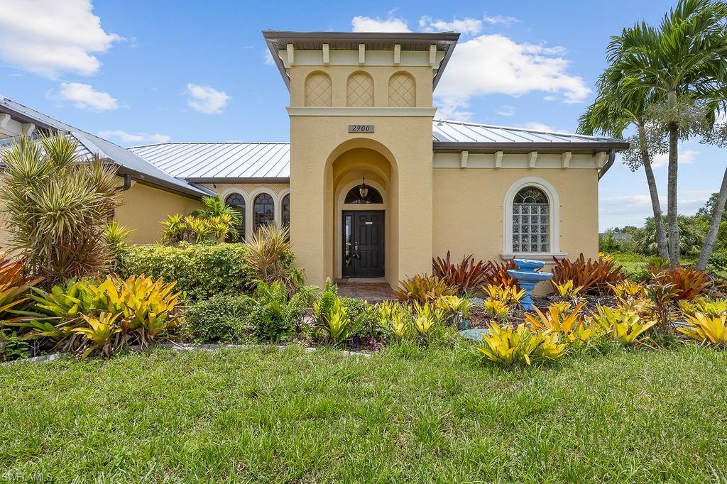 a front view of a house with a garden