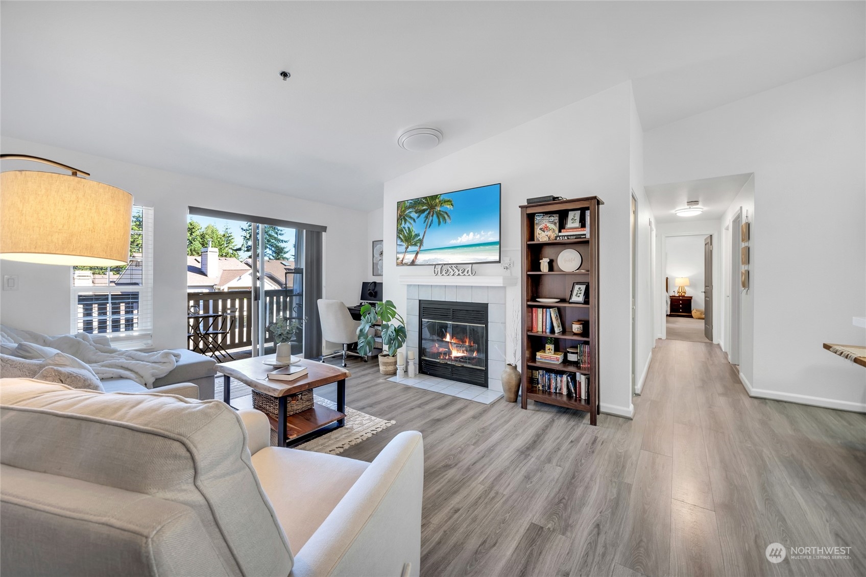 a living room with fireplace furniture and a wooden floor