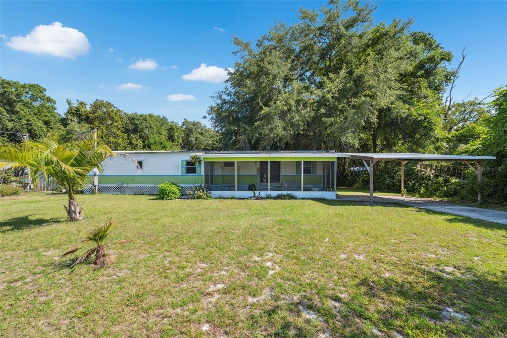 a view of a house with a backyard