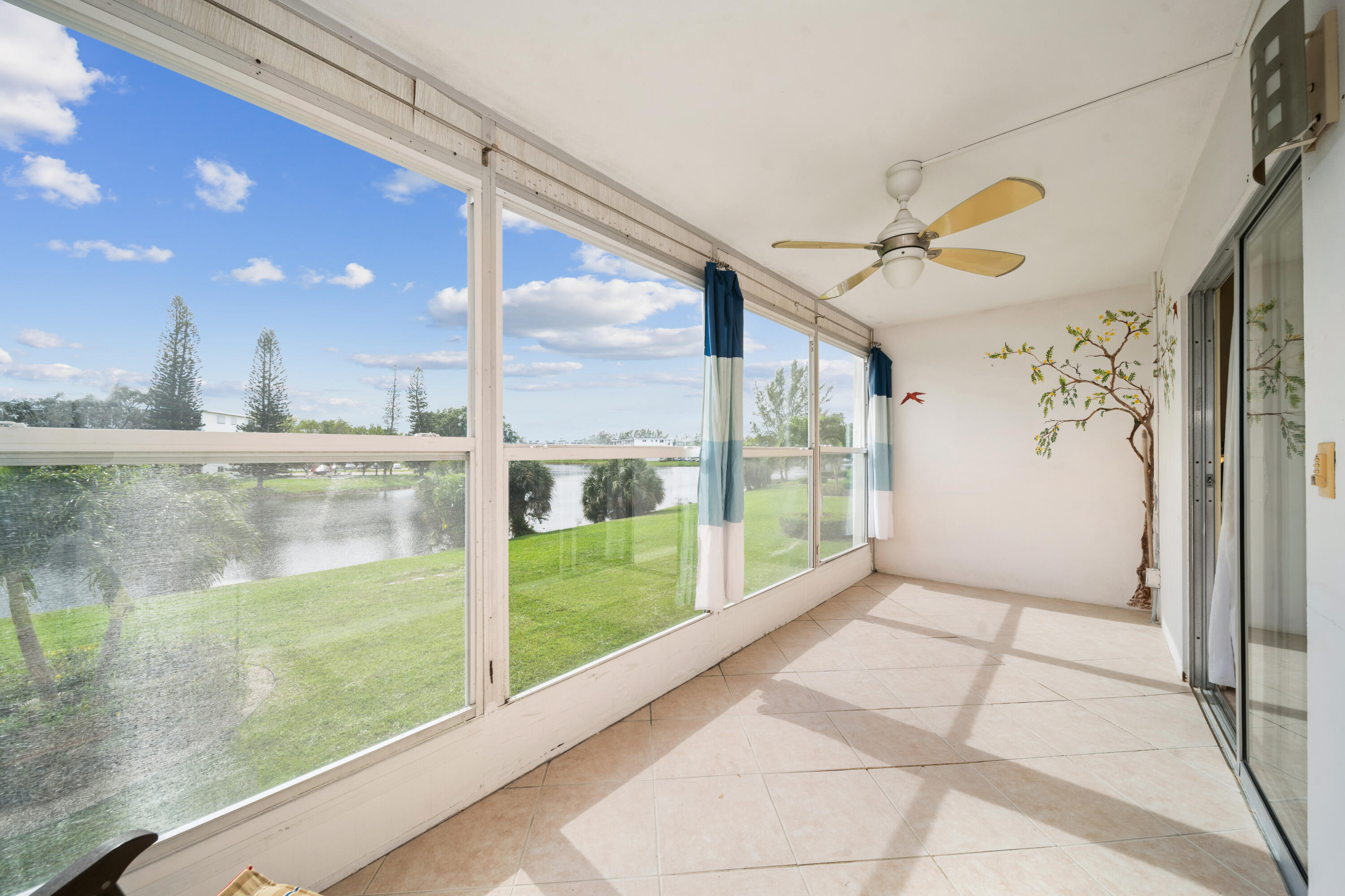 a view of a porch with a floor to ceiling window next to a yard