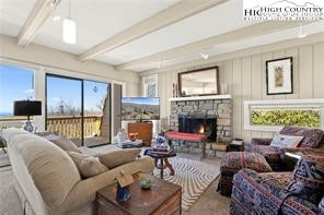 a living room with furniture fireplace and a large window