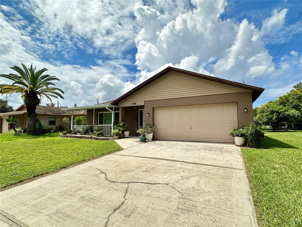 a front view of house with yard and green space