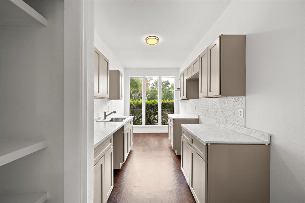 Beautifully redone kitchen with updated cabinet and countertops.